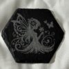Black slate coasters featuring a delicate young fairies surrounded by flowers, one smelling blooms and one dancing with wings spread